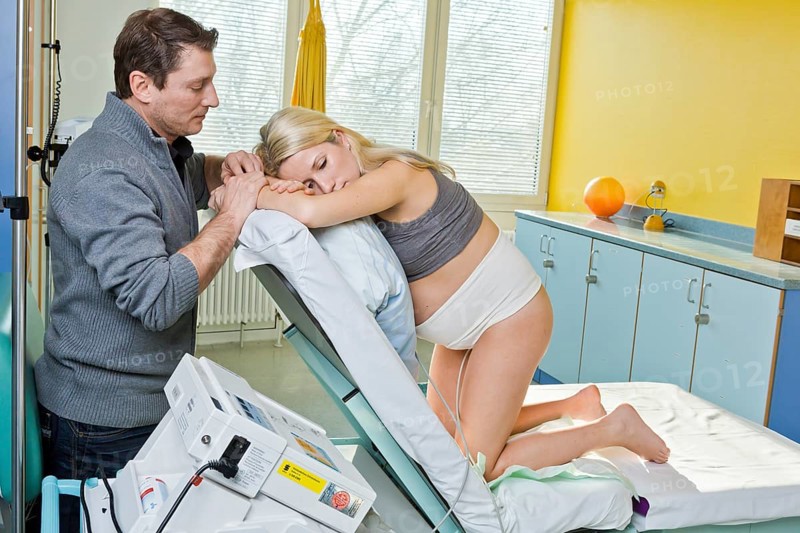 Man and woman in the delivery room during childbirth