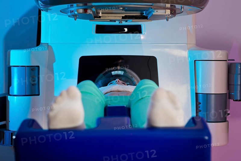 Patient lying in a linear particle accelerator for radiation treatment