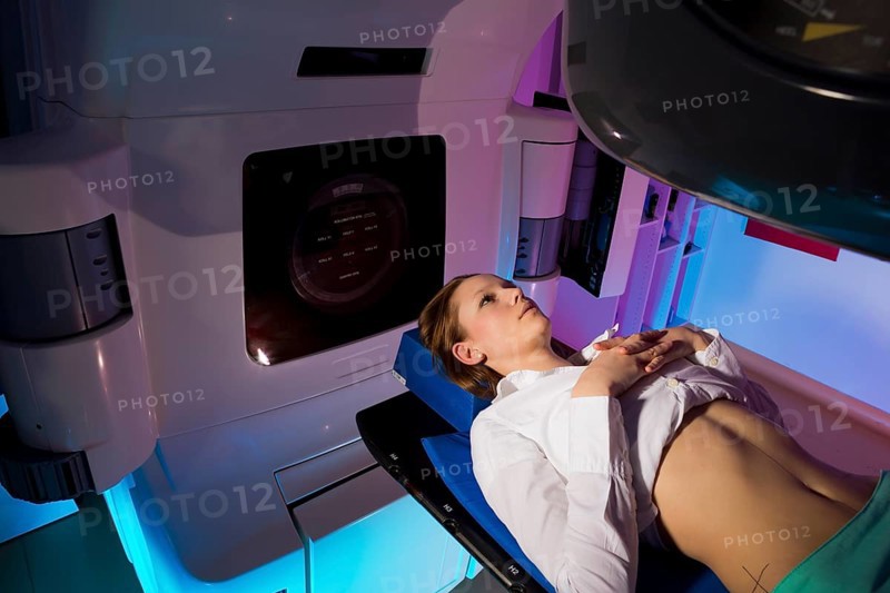 Patient lying in a linear particle accelerator for radiation treatment