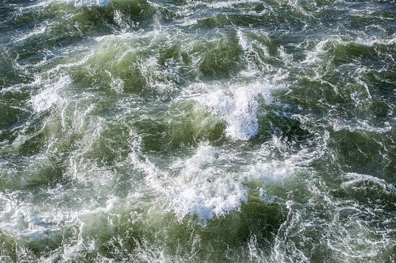 Rough waters of a river swirling after emerging from a barrage