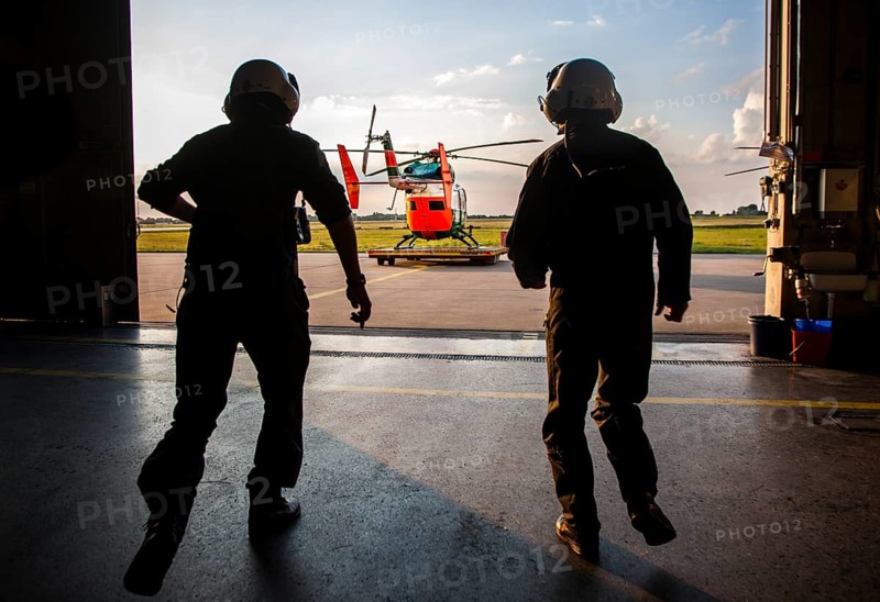 Pilots sprinting towards a helicopter