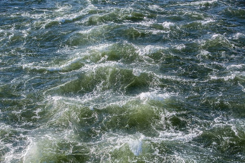 Rough waters of a river swirling after emerging from a barrage
