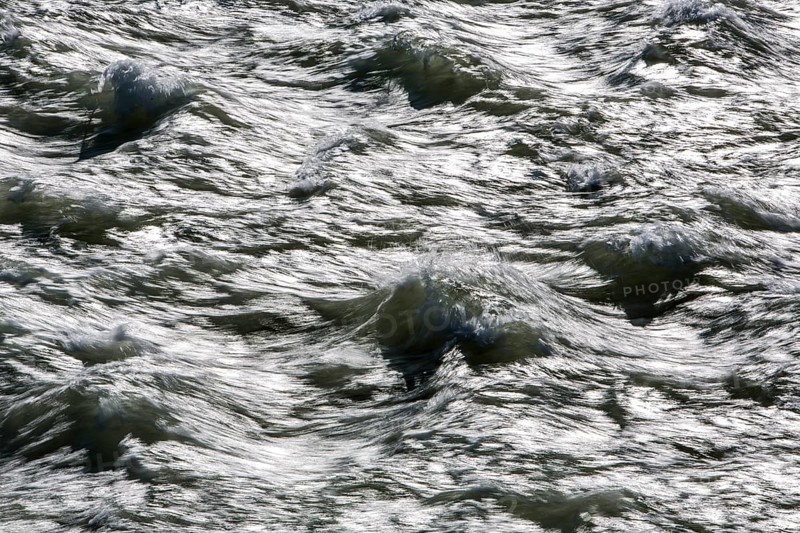 Rough waters of a river swirling after emerging from a barrage