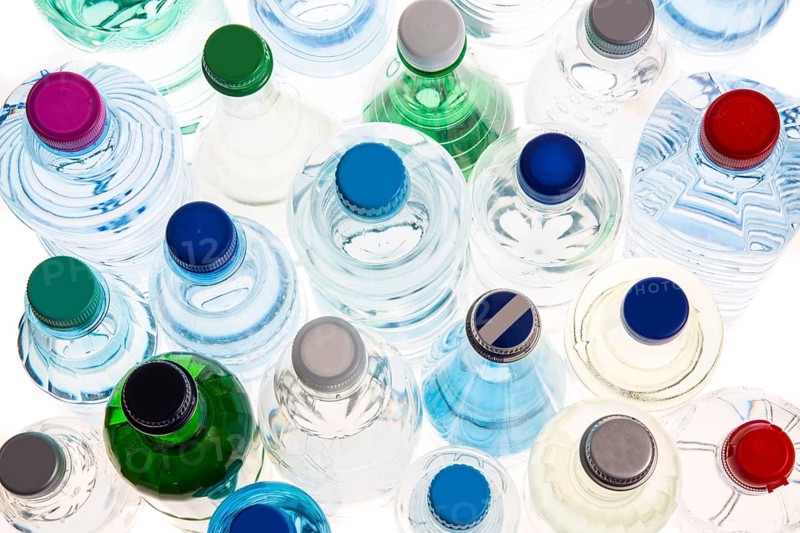 Different varieties of mineral water in bottles made of glass and plastic or PET