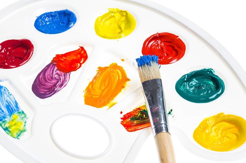 Paint palette with various acrylic paints and a brush