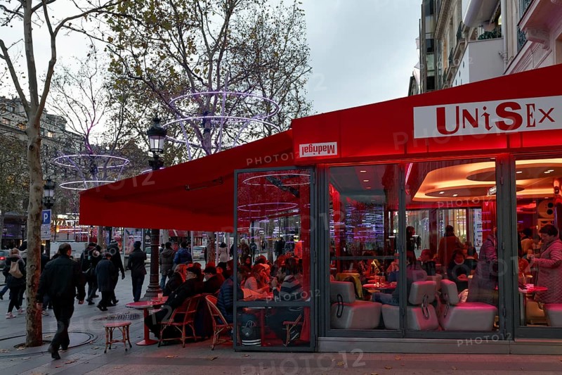 Sidewalk cafe on the Avenue des Champs Elysees street in the evening