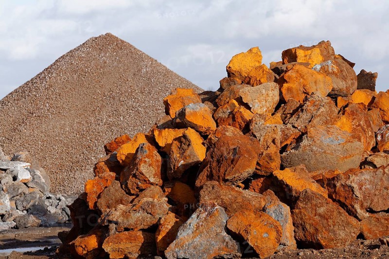 Stack of rusty ferruginous rocks waiting to be recycled
