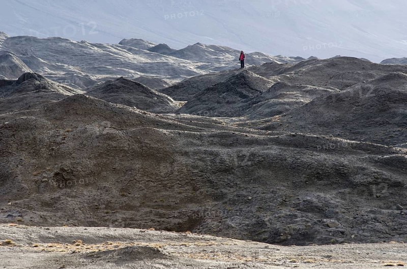 Person standing in a moraine landscape