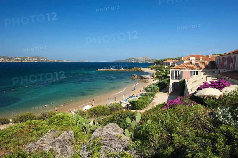 Beach of Porto Faro with the lighthouse at Capo d'Orso