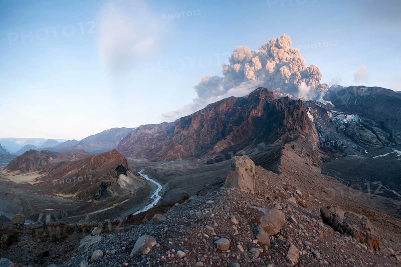 Ash cloud from Eyjafjallajoekull volcano above a glacier and Porsmoerk valley