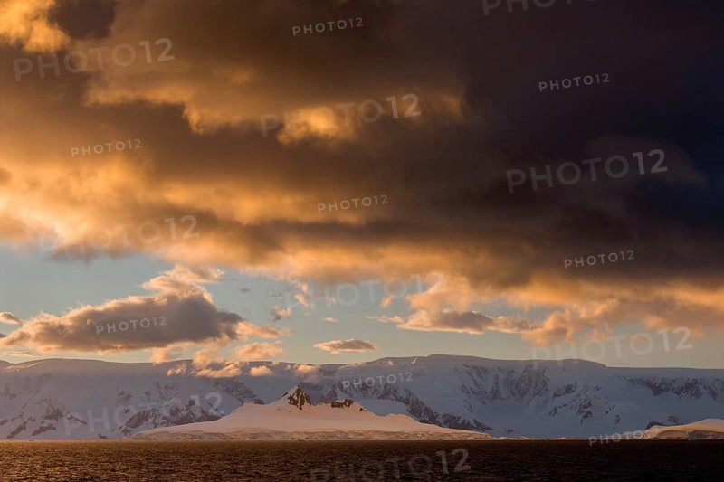 Clouds and glaciated mountains in the Gerlache Strait in the evening light