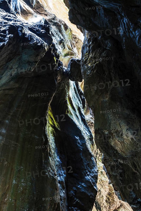 Boulder wedged between two rock faces