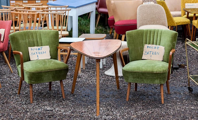 Table and armchairs from the 1960s are offered for sale at a flea market