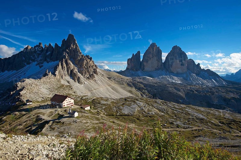 Dreizinnenhuette or Three Peaks Alpine hut and chapel in front of Paternkofel Mountain and the north face of the Three Peaks