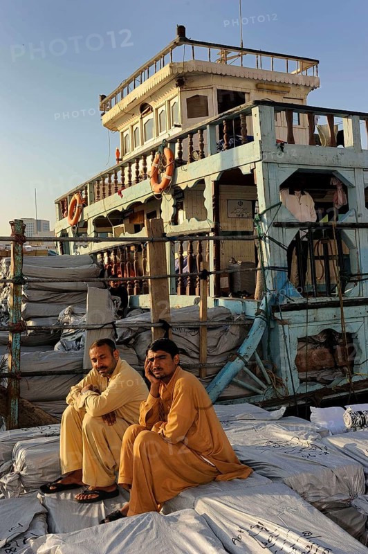 Dockers sitting on sacks on a dhow