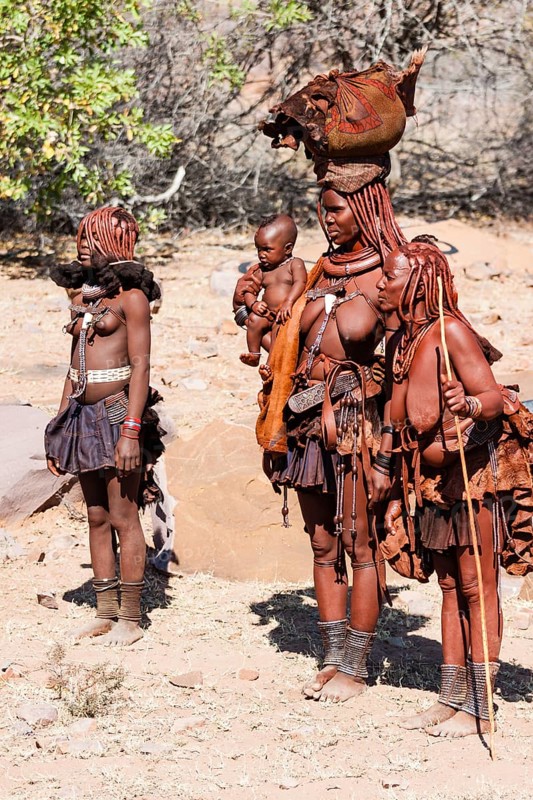 Three traditionally dressed Himba women