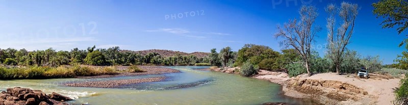 Off-road vehicle parked beside the Kunene River