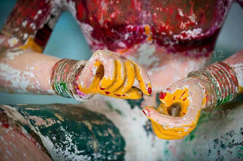 Hands of an old wooden temple figure