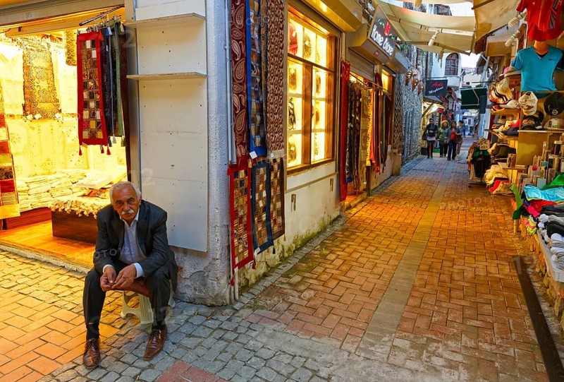 Man sitting outside a carpet shop in the Bazaar of Kusadasi