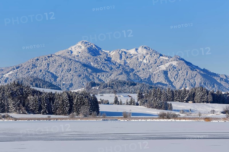 Frozen Hopfensee Lake with Mount Edelsberg and Mount Alpspitz