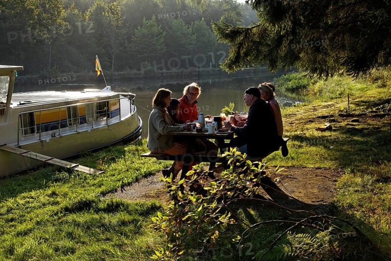 Holidaymakers having breakfast on a picnic table