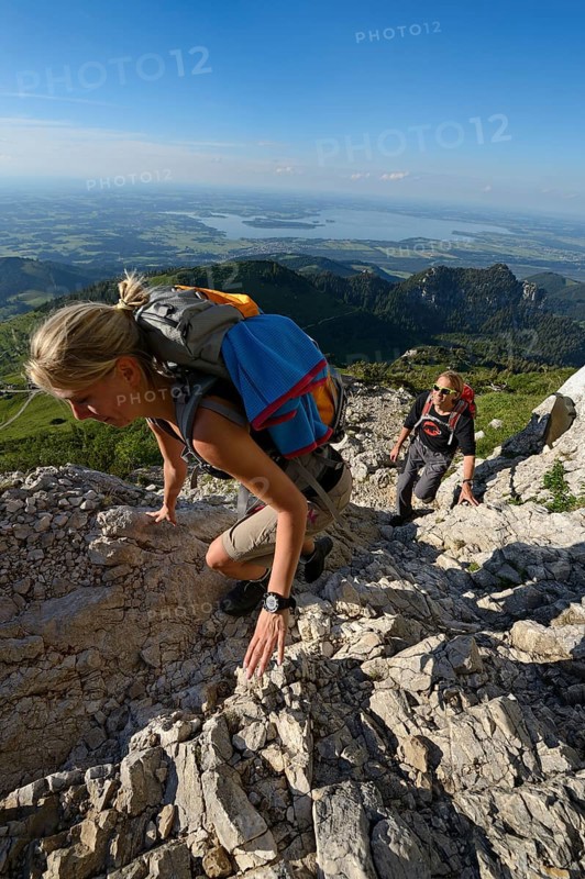 Hikers climbing to the summit of Kampenwand Mountain