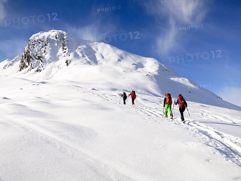 Cross-country skiers ascending a mountain