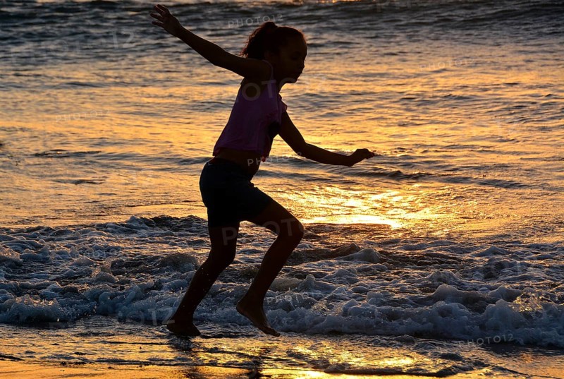 Girl playing on the beach