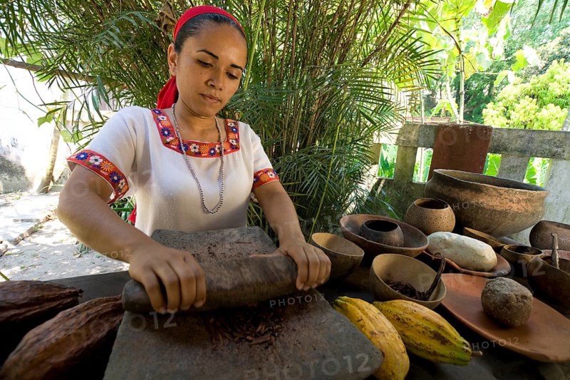 Farm worker grinding cocoa beans at the Hacianda Cacaotera 'Jesus Maria'