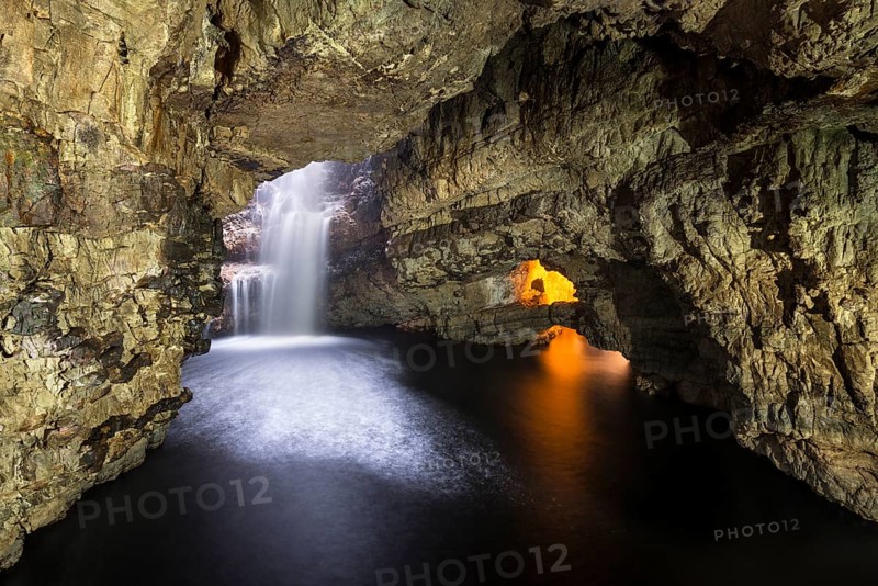 Allt Smoo stream passing through a hole in the ceiling into Smoo Cave limestone cave