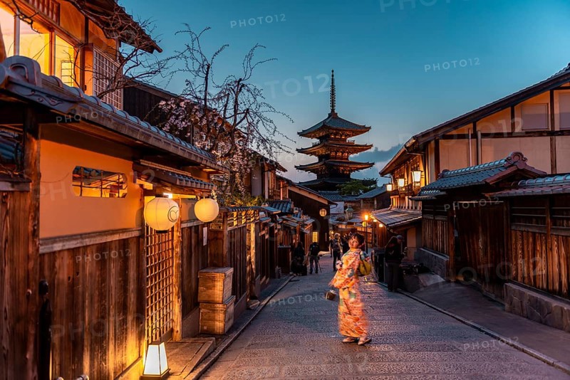 Woman in Kimono posing in an alley