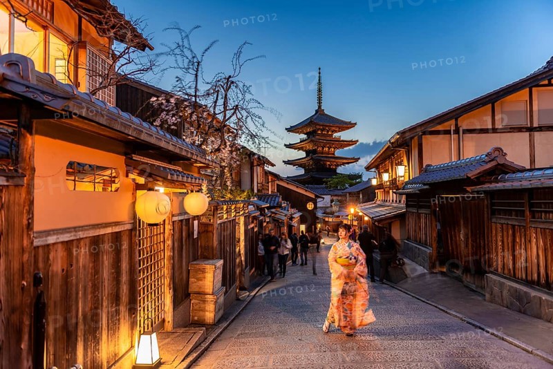 Woman in kimono in a lane