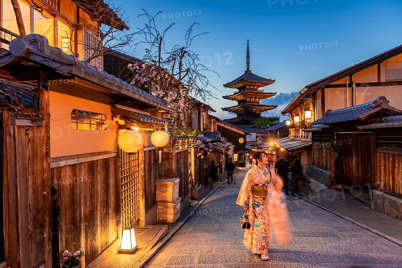 Woman in kimono in a lane