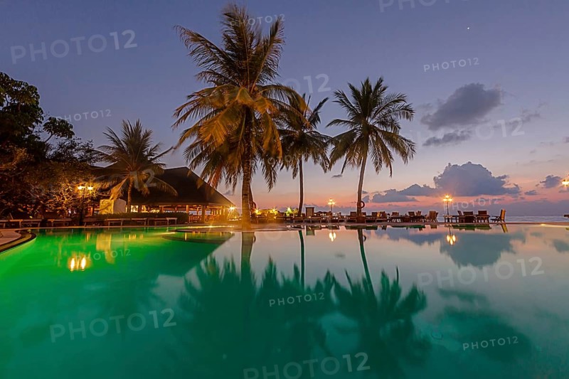 Restaurant and pool area of Paradise Island at dusk