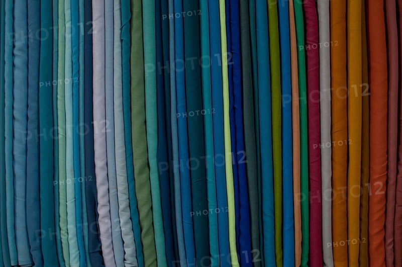 Fabrics lined up on a rack