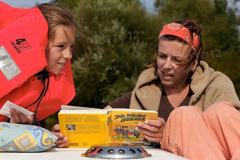 Mother and daughter reading a children's book