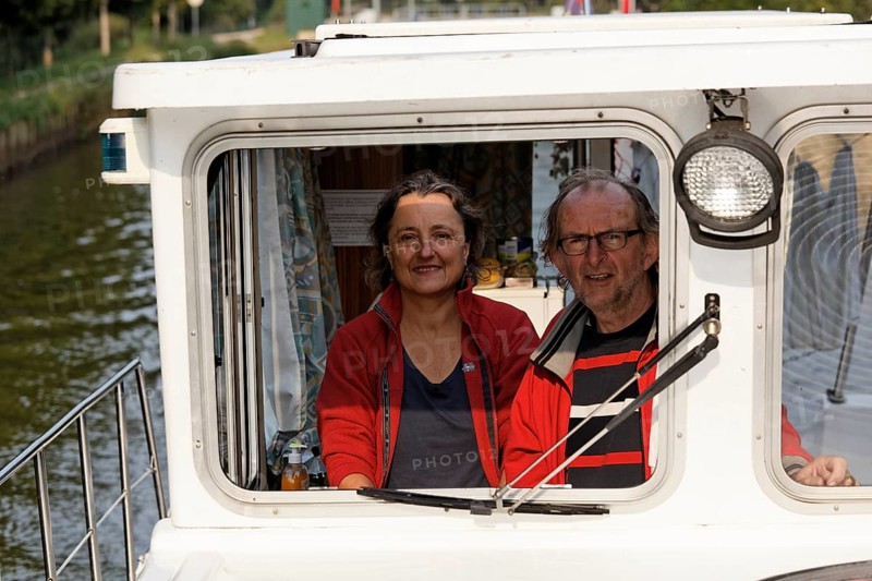 Woman and man at the wheel of a Penichette