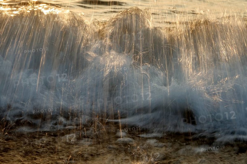 Waves on the beach of Bug on the island Ruegen in the evening sun