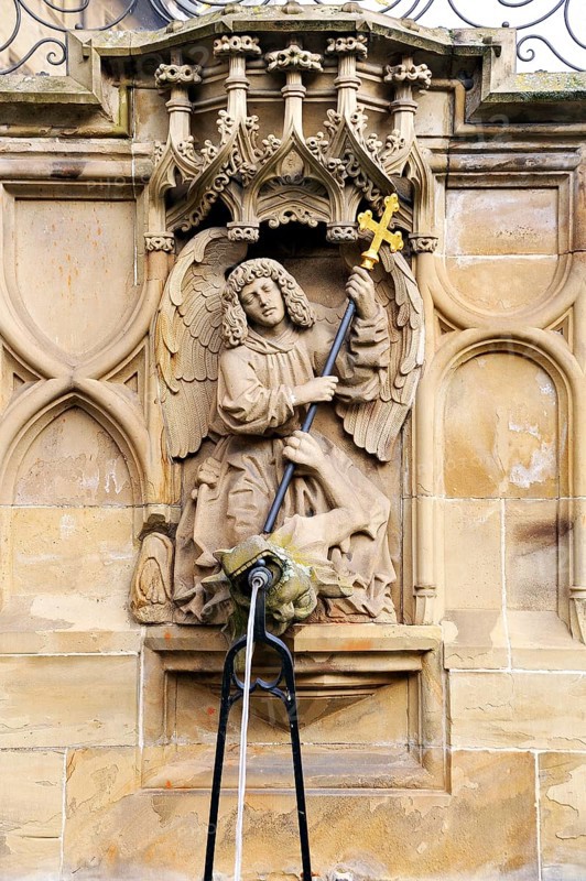 High-relief of St. Michael and the Dragon as a well figure on the Gothic Fischbrunnen fountain