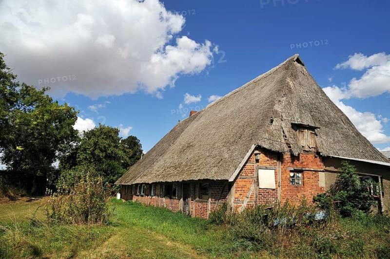 Old farmhouse with low thatched roof