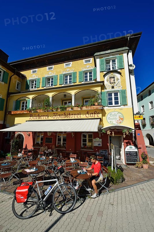 Cyclist having a break outside Cafe Cupido