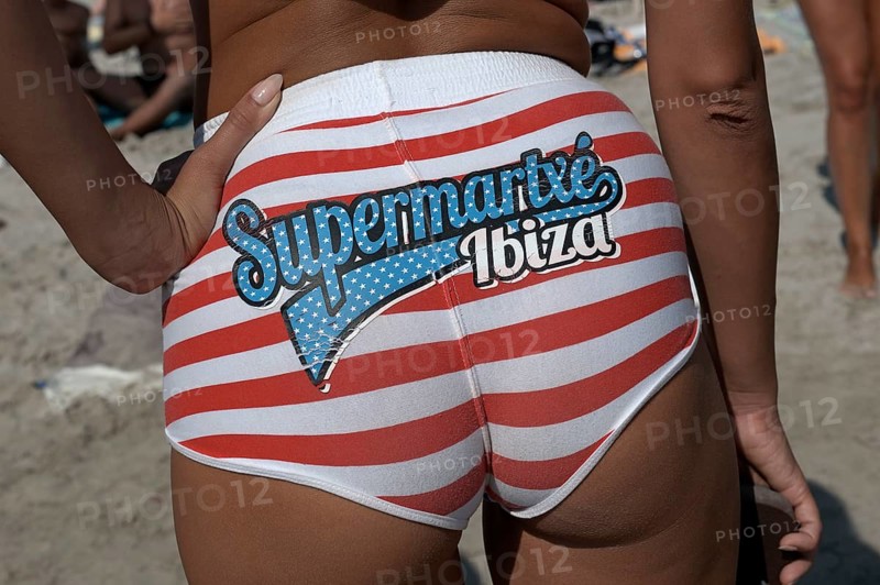 Female member of a promotional team from one of the big clubs adverting the club 'Supermartxe' on her bikini bottoms