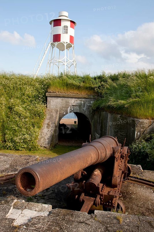 An old cannon and a beacon at Trekroner Sofort or Three Crowns Sea Fortress