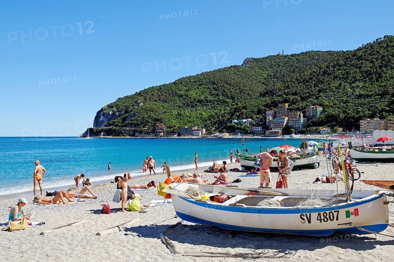 Fishing boats and bathers on the beach of Noli