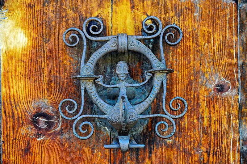 Wrought-iron door knocker with a figure