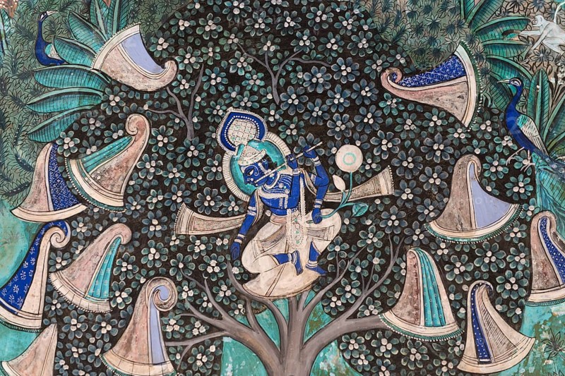 Pastoral god Krishna playing on his flute after he has hidden the clothes of the shepherd girls in a tree