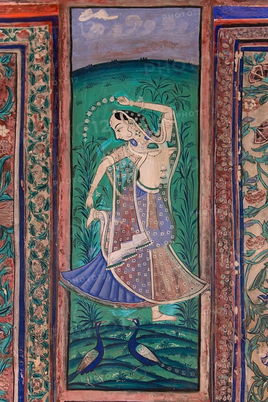 Dancing woman with two peacocks
