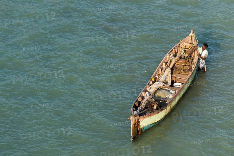 Fisherman with his fishing boat