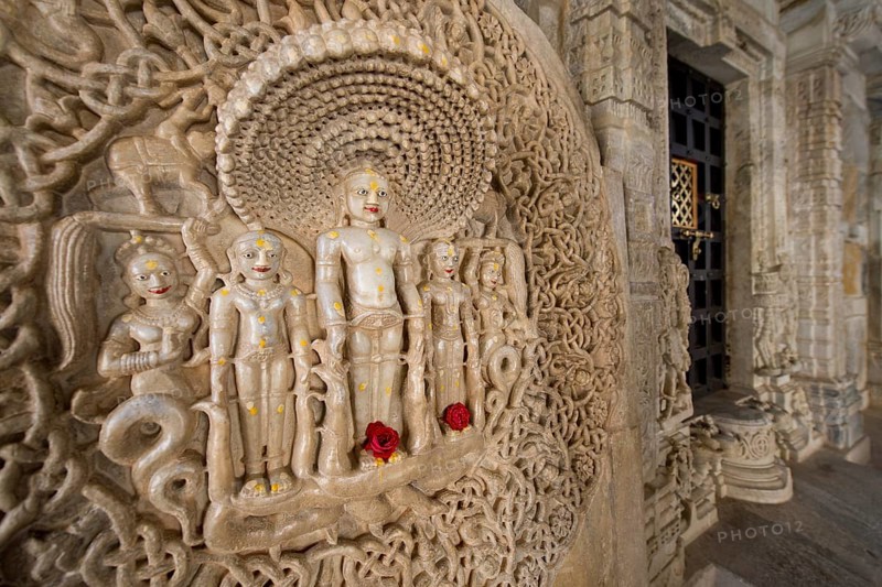 Tirthankar Parshvanat in the medallion protected by the thousand-headed serpent God Dharanendra against a powerful storm