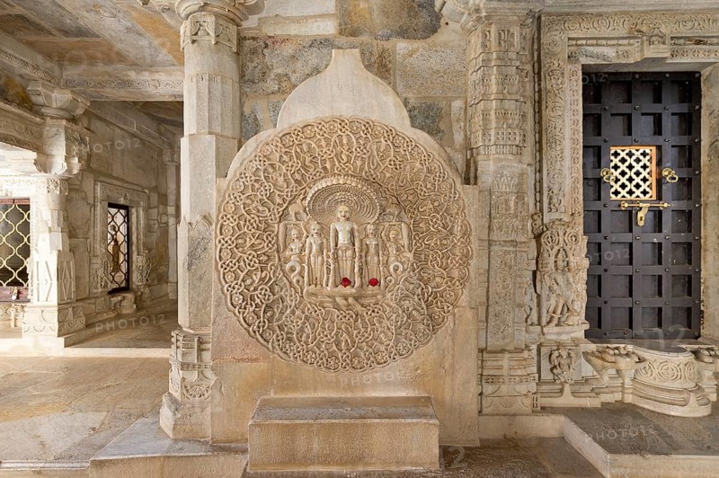 Tirthankar Parshvanat in the medallion protected by the thousand-headed serpent God Dharanendra against a powerful storm